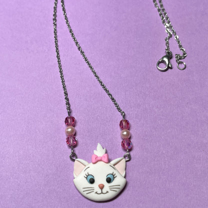 Necklace with a cat-shaped pendant on a purple background